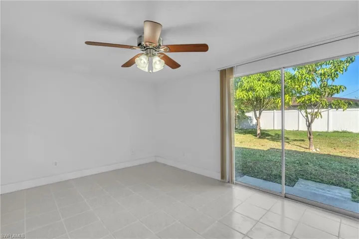 Empty room with baseboards and ceiling fan