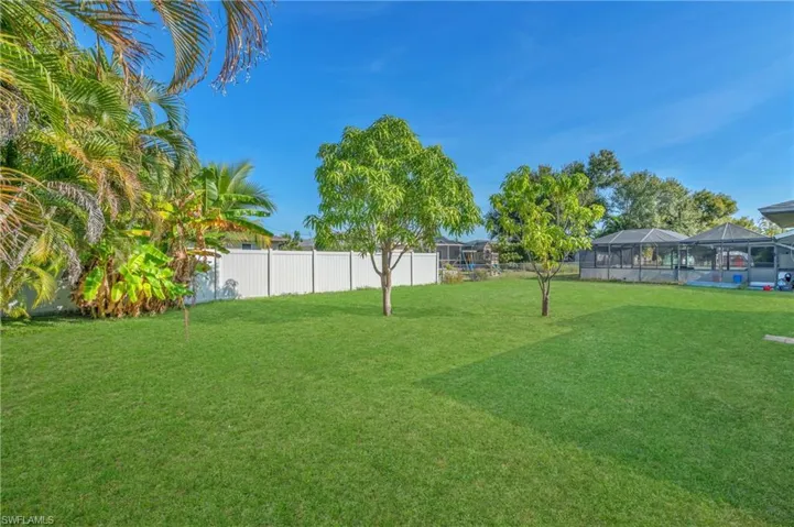 Fenced backyard with a sunroom