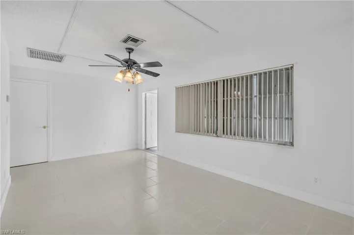 Empty room featuring a textured ceiling and a ceiling fan