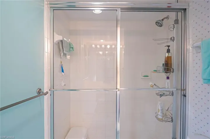 Full bathroom with a shower stall