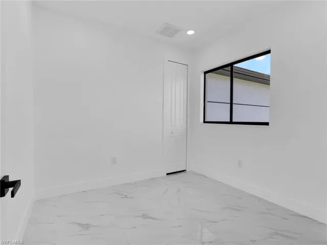 Spare room with light marble finish flooring and recessed lighting