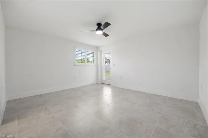 Guest bedroom with walk-in closet, ensuite full bath, and private access to the screened lanai.