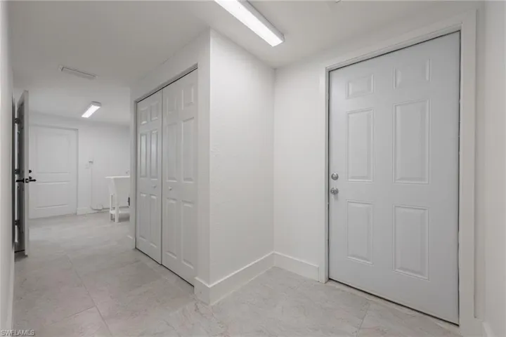 Laundry area with access to both the garage and exterior of the home