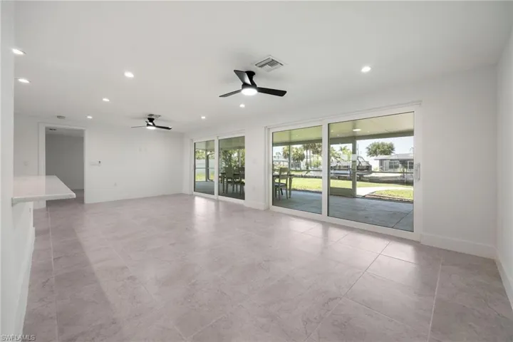 Unfurnished room with plenty of natural light, recessed lighting, ceiling fan, and a sunroom