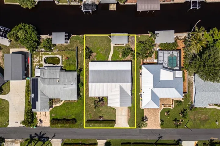 Aerial view of property and surrounding area with property parcel outlined