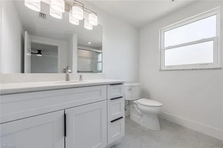 Full guest bathroom with vanity, walk-in shower