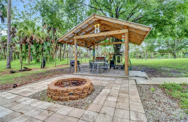 View of patio with a gazebo and an outdoor fire pit