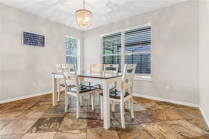 Dining area featuring tile floors and a notable chandelier