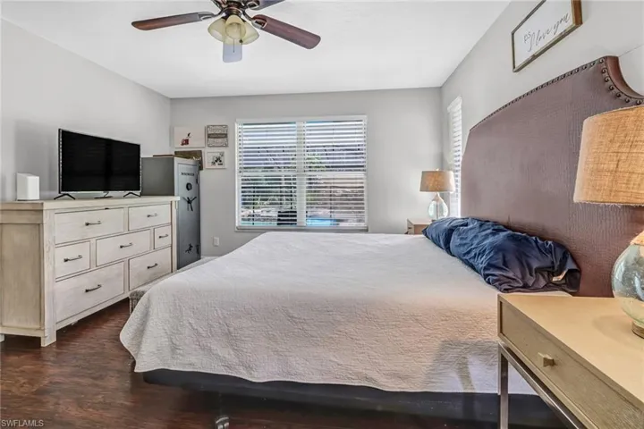 Bedroom with dark wood-type flooring and ceiling fan