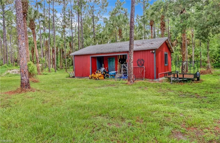 View of outdoor structure featuring a lawn