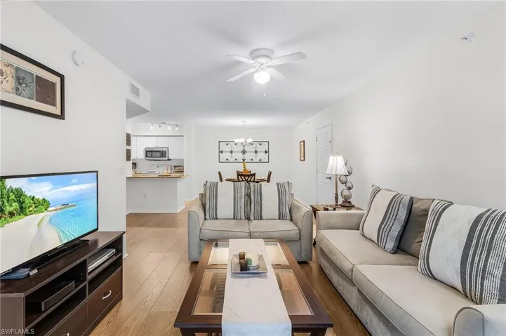 Living area featuring laminate flooring and ceiling fan