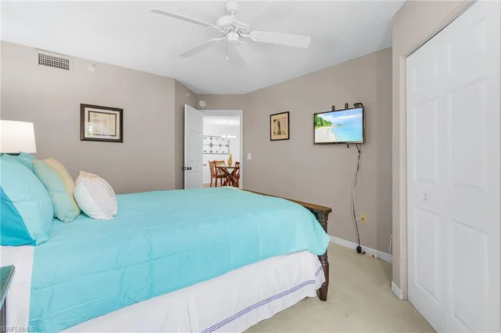 Bedroom featuring light colored carpet and ceiling fan