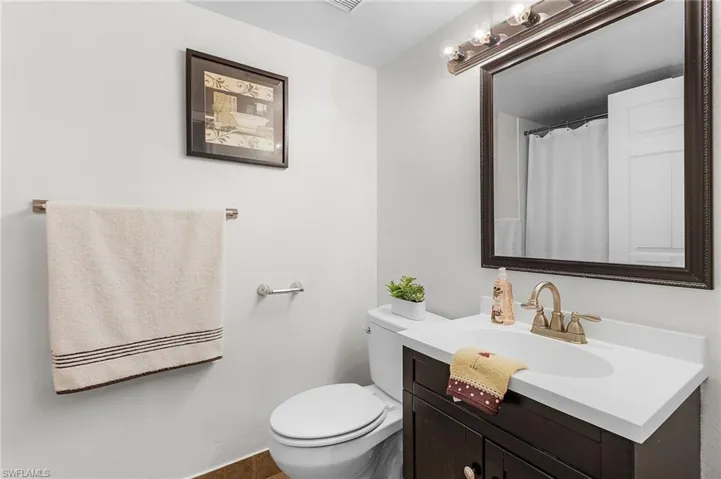 Full bathroom with vanity and toilet and large tub/shower combo