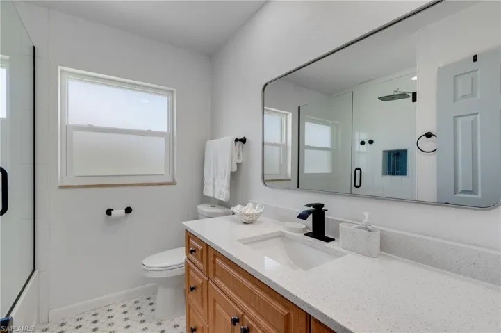 Updated guest bath with quartz vanity and walk-in shower
