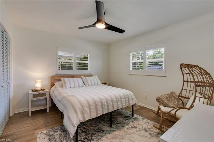Comfortable guest bedroom with plantation shutters