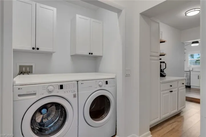 Dedicated laundry area with built-in cabinetry