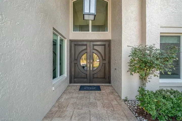 Doorway to property with stucco siding