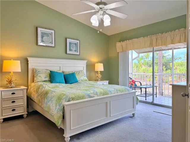 Bedroom featuring carpet floors, access to outside, lofted ceiling, and a ceiling fan