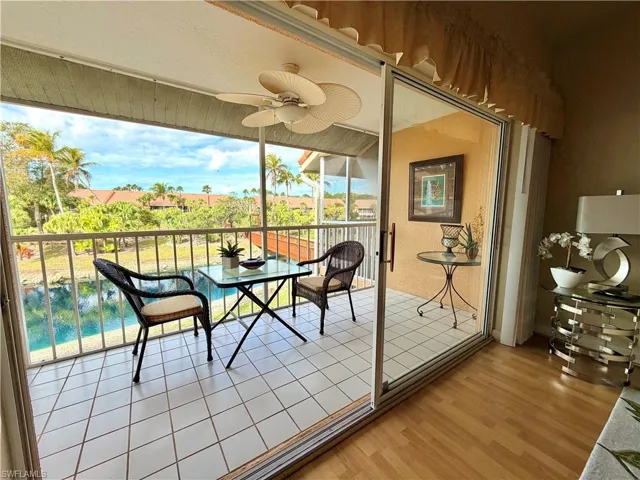 Back lanai/ Sunroom featuring ceiling fan