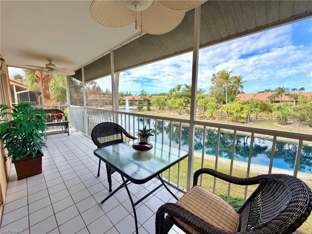 Back lanai/ Sunroom with a ceiling fan and a water view