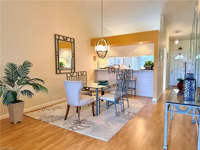 Dining area featuring light wood-style floors and hanging lights