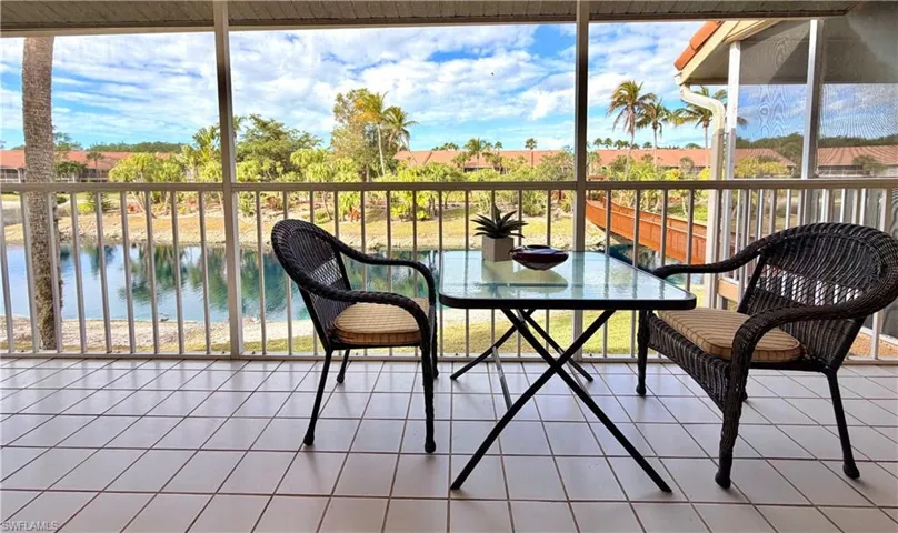 Back lanai/ Sunroom featuring a water view and tile patterned floors