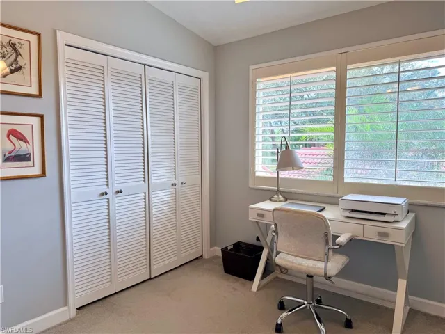 Office featuring light carpet and baseboards