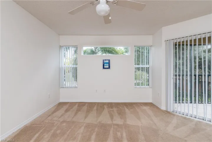 Great Room with ceiling fan, and light carpet