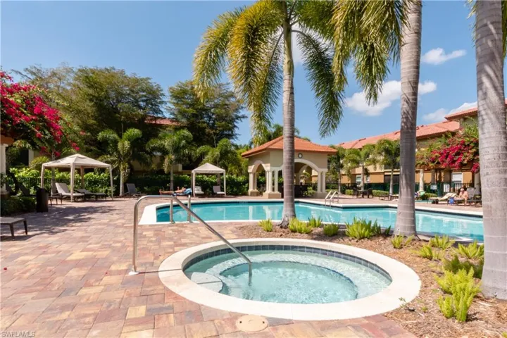 View of swimming pool featuring a cabana and a hot tub