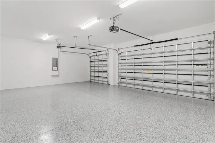 Garage featuring electric panel and a garage door opener