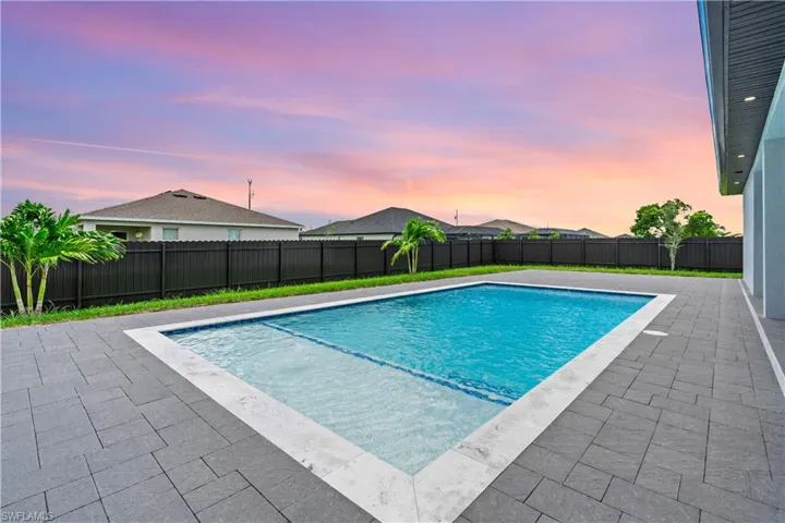 Pool at dusk with a patio