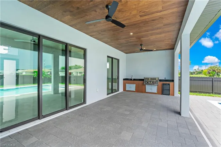 View of patio featuring area for grilling and ceiling fan