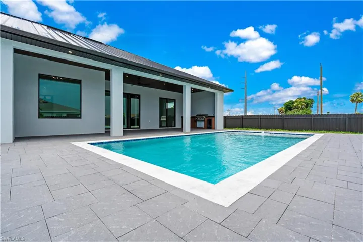 View of pool featuring pool water feature and a patio area