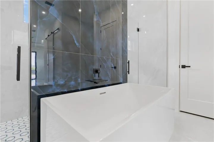 Bathroom with tile patterned flooring and tile walls