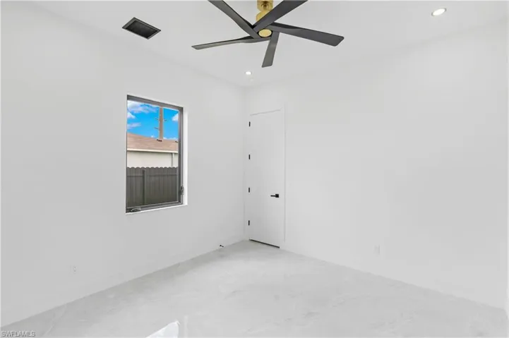 Empty room with concrete flooring and ceiling fan