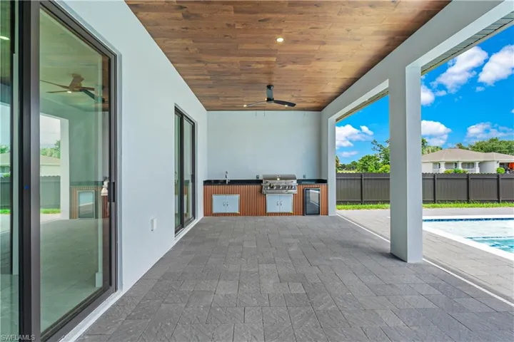 View of patio / terrace featuring a grill, a pool, area for grilling, and ceiling fan