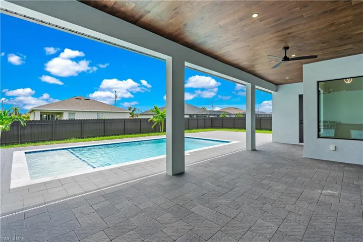 View of pool featuring a patio area and ceiling fan