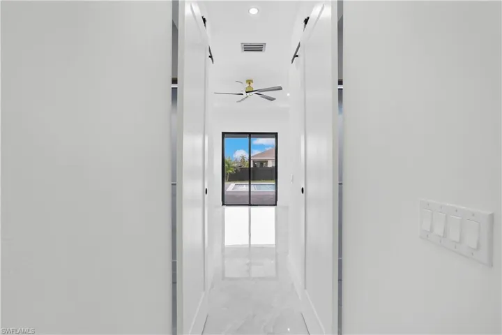 Hall featuring tile patterned flooring
