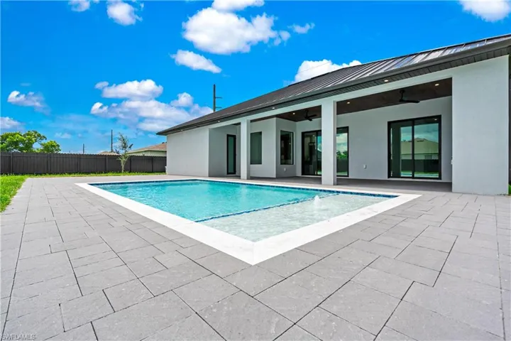 View of swimming pool with a patio and ceiling fan