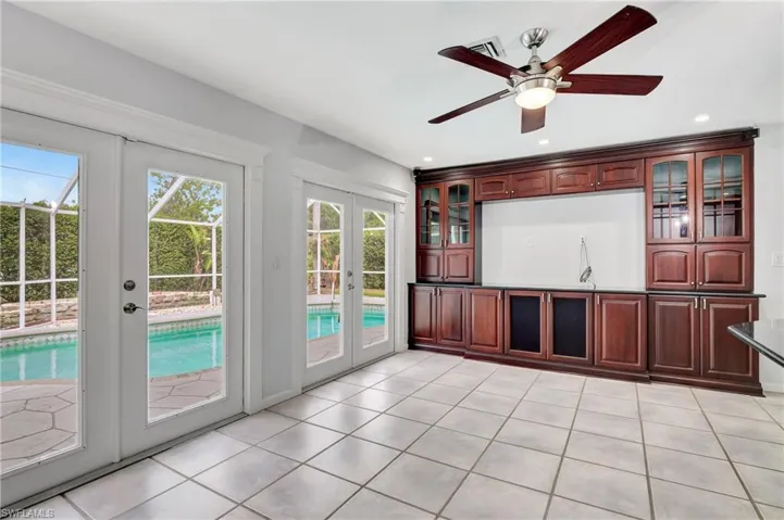 Unfurnished living room featuring french doors, ceiling fan, light tile patterned floors, and recessed lighting