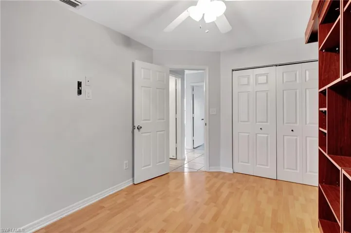 2nd guest  room featuring ceiling fan and light wood-type flooring bedroom with light wood-style flooring, a ceiling fan, and a closet