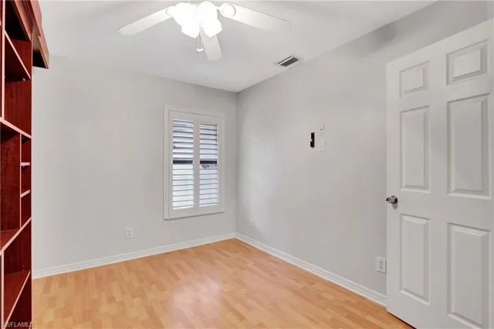 2nd guest  room featuring ceiling fan and light wood-type flooring.