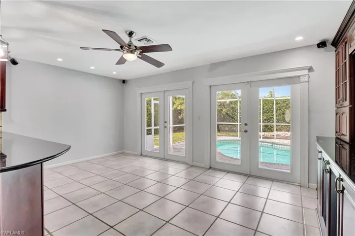 Unfurnished dining area with french doors, ceiling fan, recessed lighting, and light tile patterned flooring