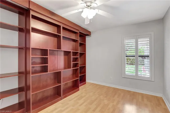 Unfurnished bedroom featuring light wood-style floors and ceiling fan.