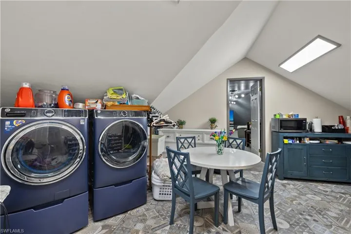 Upstairs Washroom with laundry area and washing machine and clothes dryer