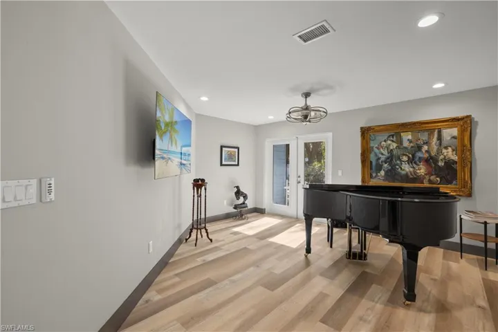 Den area featuring french doors, and recessed lighting