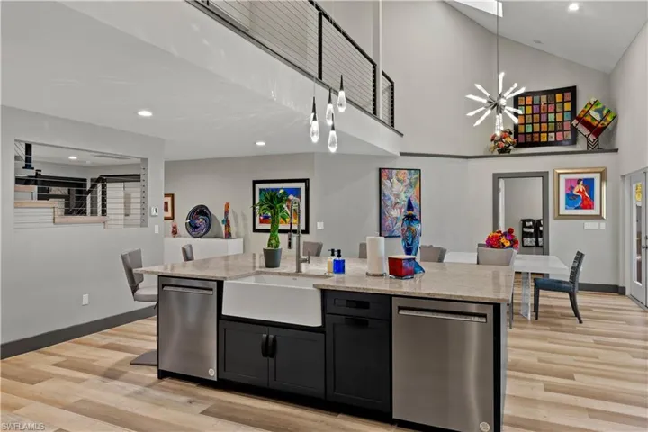Quartz Island in kitchen that features 2 dishwashers and a farmer's style sink
