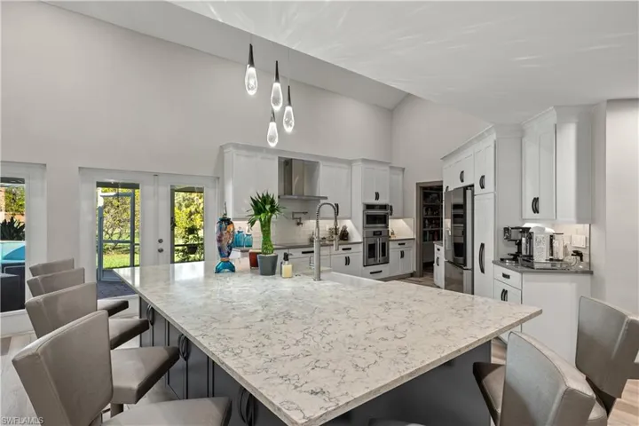 Very large Island in Kitchen with plenty of seating for entertaining and tasteful backsplash