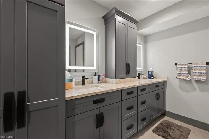 Master bath with quartz double vanity and plenty of cabinet space.