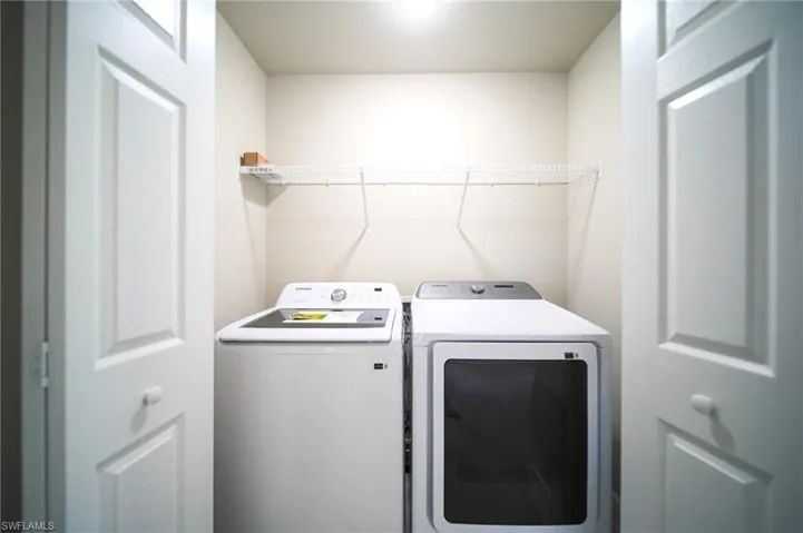 The Laundry Area Comes With A Brand New Washer & Dryer And Metal Shelving!